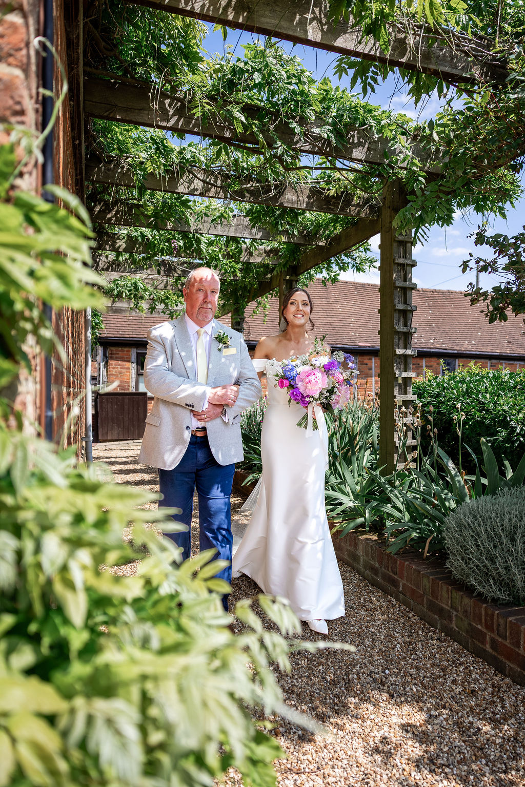 SJTD14-06-25HR-133 Father and bride walking towards the garden wedding ceremony at Polehanger