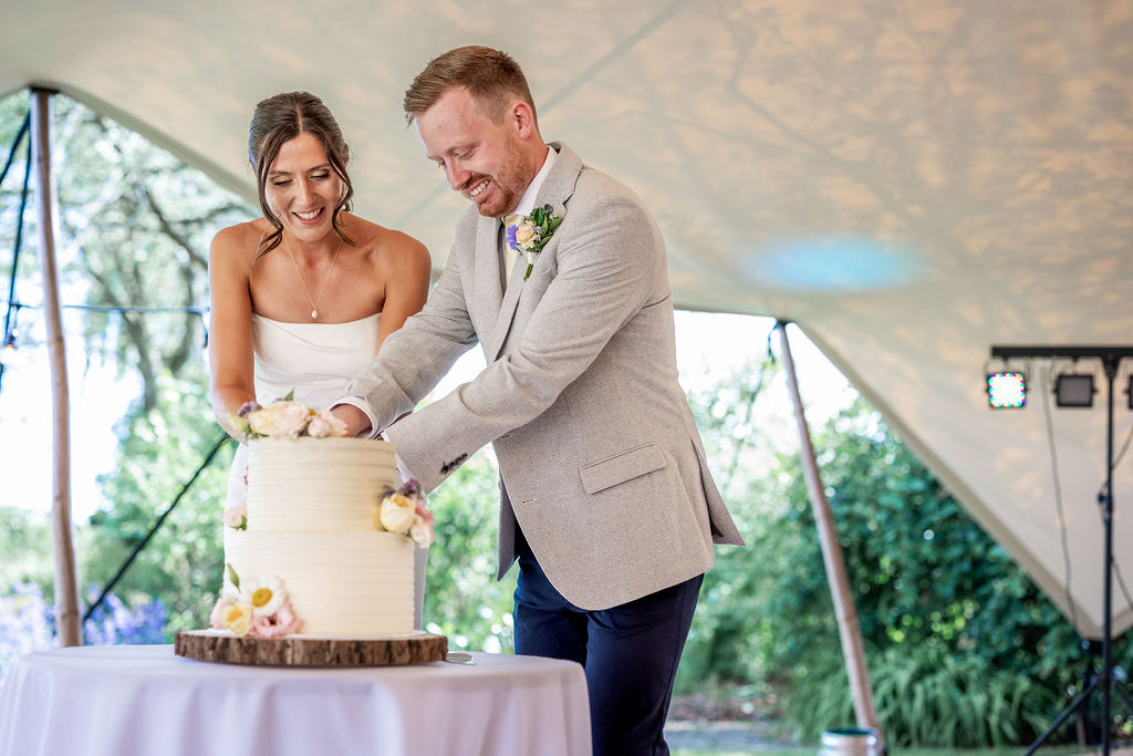 SJTD14-06-25HR-343 Cutting the cake under the stretch tent by Funky Monkey Tents setup at The Gardens at Polehanger